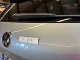 a silver car with a sticker on the back of it