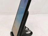 a close up of a cell phone on a stand on a table