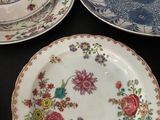three plates with different designs on them sitting on a table
