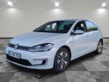 a white volkswagen e - golf parked on a checkered floor