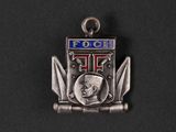 a close up of a metal badge on a black surface