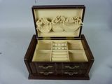 a small wooden box with a bunch of jewelry inside of it