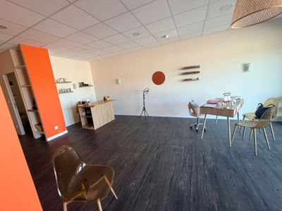 a room with chairs, a table, and a television in it
