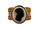 an image of a gold ring with a black and white silhouette of a man