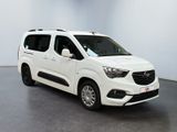 the white van is parked in a room with a gray floor