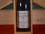 a bottle of wine in a wooden box on a table