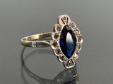 an image of a ring with a blue stone in it