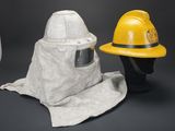 three different types of fire helmets and a hat on a black background