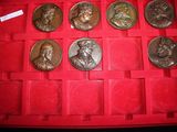 a lot of coins in a red case on the table