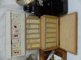 a small wooden box with a lot of items inside of it