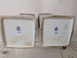 two white and blue plates with blue designs on them