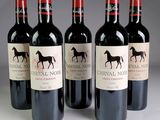 four bottles of red wine are lined up in a row