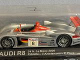 a silver and orange race car in a clear box