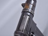 a close up of a gun on a white surface