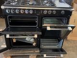 a black stove with two ovens on top of a pallet
