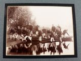 a black and white photo of a group of people on a boat