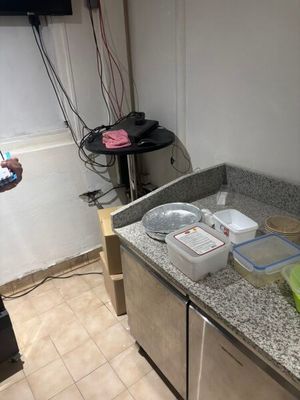 a person taking a picture of a kitchen counter with a cell phone