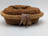woven basket with a brown ribbon on a white background