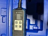 a remote control in a blue case on a table