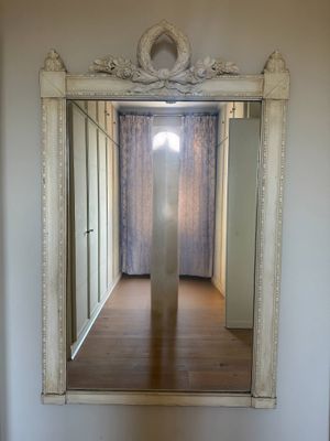 a mirror on the wall in the hallway of a house