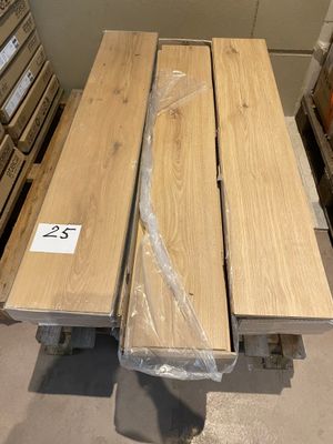 two pieces of wood are stacked on a pallet in a warehouse