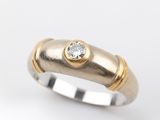 a close up of a ring with a diamond on top of it