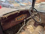 an old car that is sitting in a parking lot