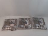 three bags of coffee sitting on a white table
