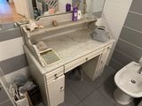 a bathroom with a sink, toilet, and mirror in it