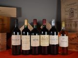 several bottles of wine are lined up on a red table