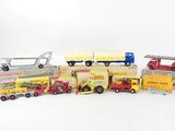 a lot of toy trucks and cars on a white surface