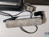 an image of a hair dryer and a brush on a counter