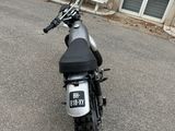 a motorcycle parked in front of a building on the street