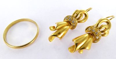 a close up of two gold rings and a pair of earrings