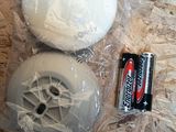 a plastic ball and a battery sitting on a table