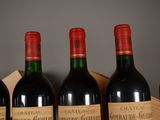 several bottles of wine are lined up on a shelf