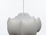 a white object hanging from a metal hook on a pole