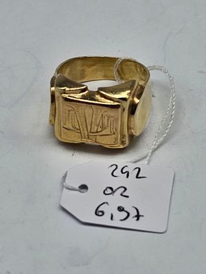 a gold ring with an egyptian design on it