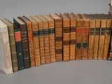 several old books are stacked on top of each other on a table