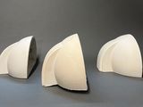 three pieces of white paper are sitting on a table