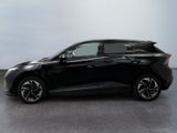 the black car is parked on the concrete floor in the room