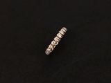 a diamond eternity ring on a black surface