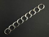 a close up of a metal chain on a black surface