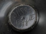 a close up of a black fire hydrant with writing on it