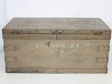 an old metal box sitting on top of a white table