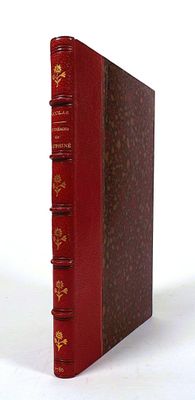 a red book that is sitting on a white surface