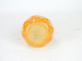 an orange and yellow glass object on a white surface