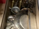 a box full of silver items sitting on a table