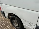 a white van that has been vandalized and is parked on the side of the road