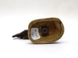 an old bronze figurine of a bird with a tag on it